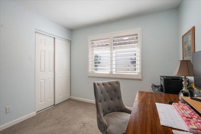 carpeted office space featuring baseboards