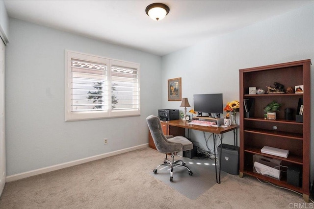 carpeted office space featuring baseboards