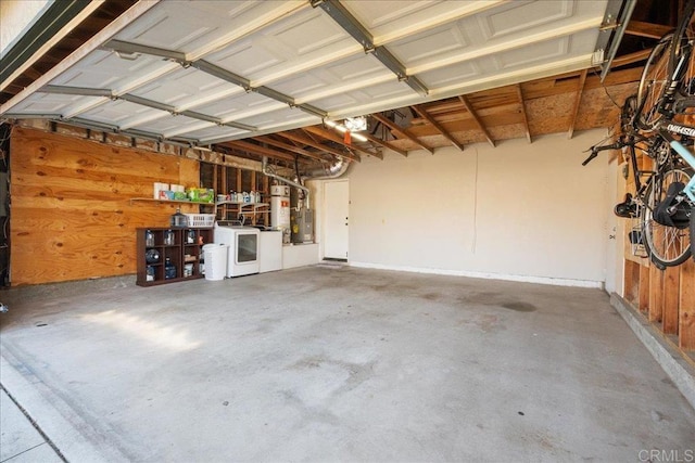 garage with secured water heater and washer and dryer