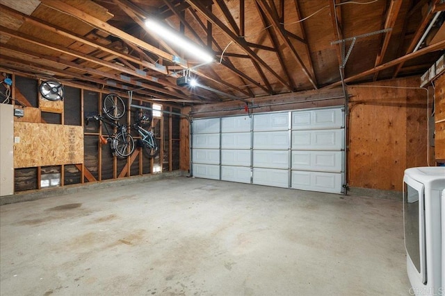 garage with washer / dryer and a garage door opener