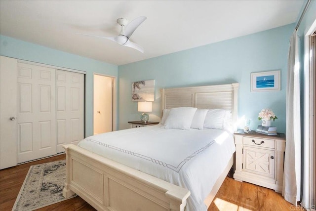 bedroom featuring a closet, ceiling fan, and light wood-style flooring