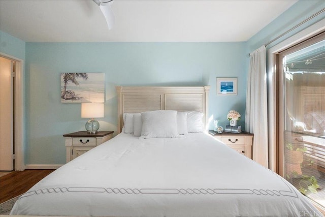 bedroom featuring ceiling fan, baseboards, and wood finished floors