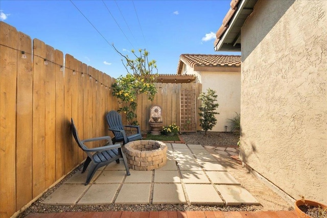 view of patio / terrace with an outdoor fire pit and a fenced backyard