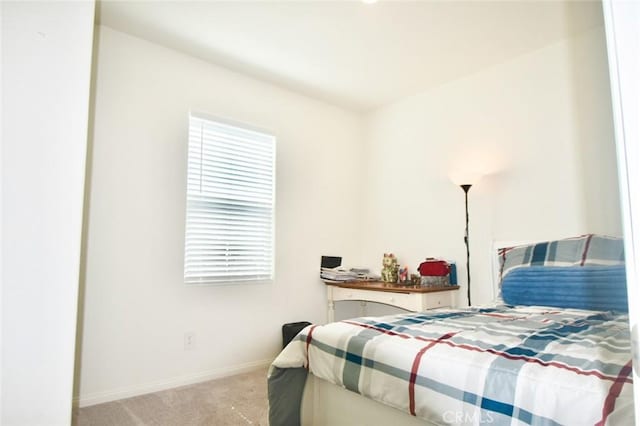 carpeted bedroom with baseboards