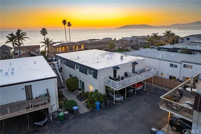 aerial view at dusk featuring a residential view and a mountain view