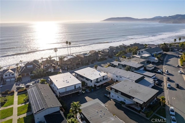 birds eye view of property with a water view, a residential view, and a view of the beach