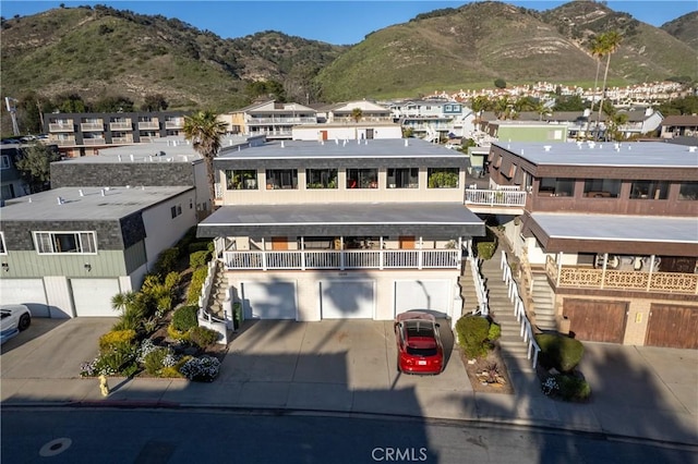 view of front facade with a garage, stairs, and concrete driveway