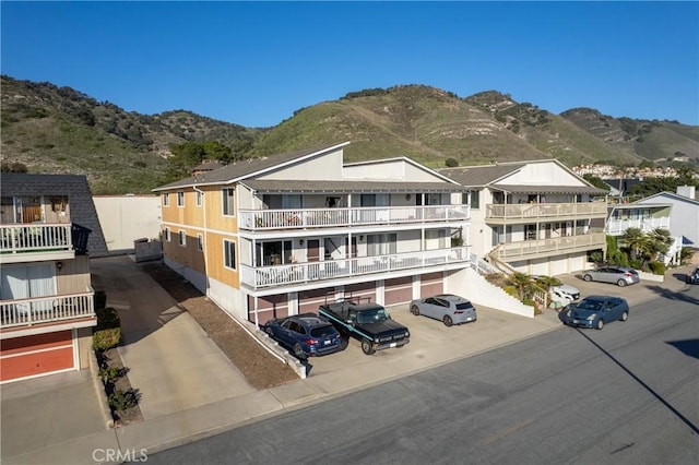 view of front of home with uncovered parking and a mountain view