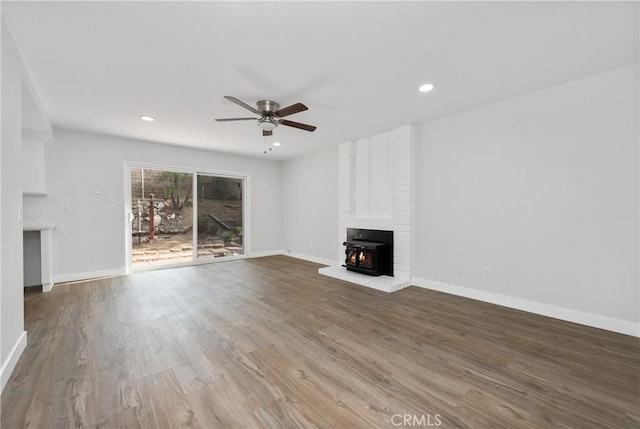 unfurnished living room featuring ceiling fan, baseboards, and wood finished floors