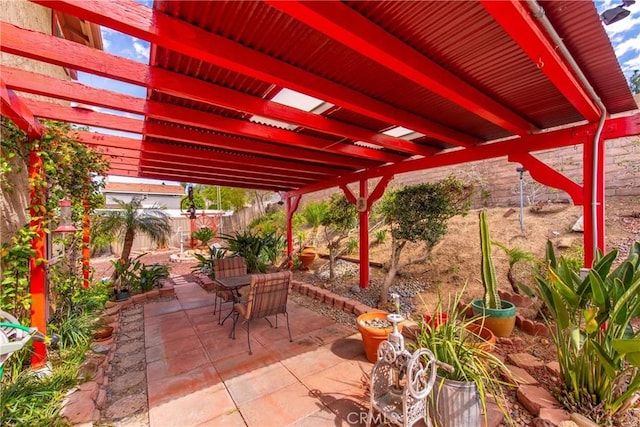 view of patio / terrace with a fenced backyard, outdoor dining space, and a pergola