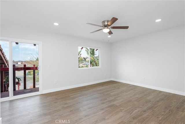 unfurnished room featuring recessed lighting, wood finished floors, baseboards, and ceiling fan