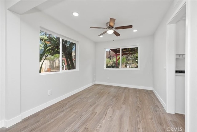 empty room featuring recessed lighting, a ceiling fan, baseboards, and wood finished floors