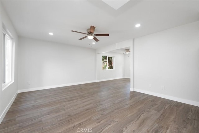 unfurnished room featuring a ceiling fan, recessed lighting, wood finished floors, and baseboards