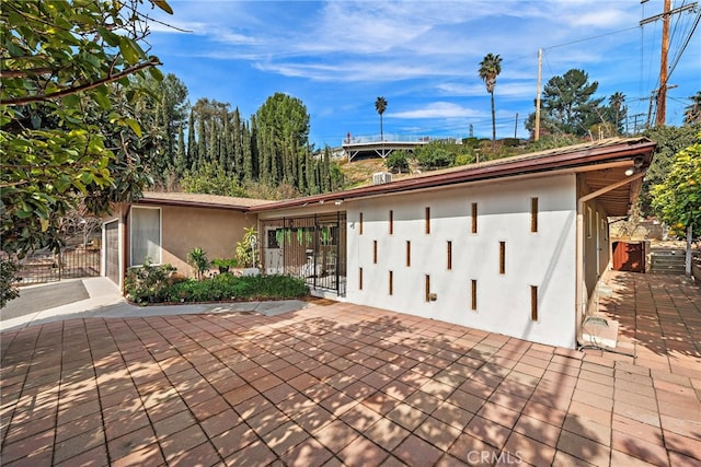 view of front of home featuring a gate, fence, and stucco siding