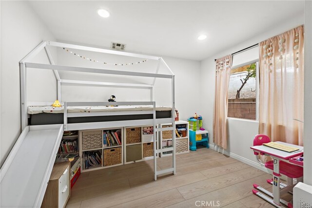 bedroom with recessed lighting, visible vents, baseboards, and wood finished floors