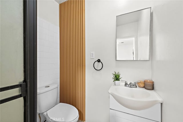 bathroom featuring toilet and vanity