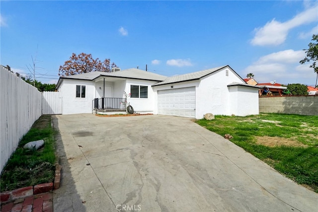 single story home with a garage, stucco siding, driveway, and fence