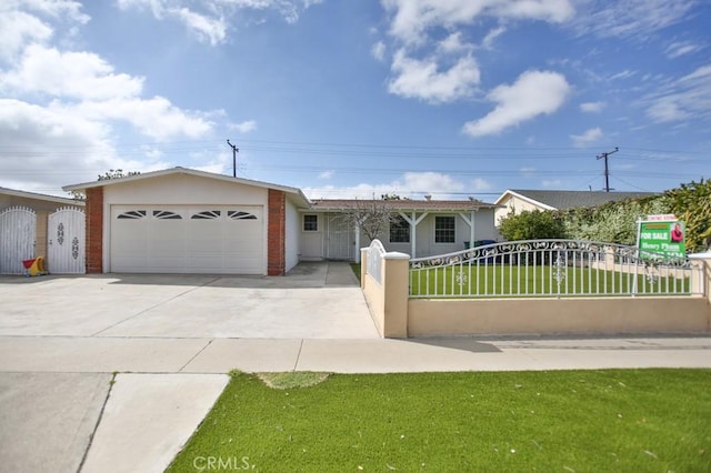 ranch-style house featuring concrete driveway, a fenced front yard, an attached garage, a gate, and a front yard