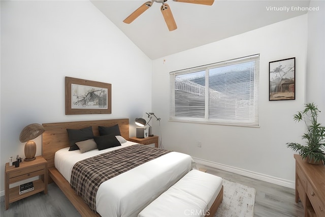 bedroom featuring lofted ceiling, wood finished floors, a ceiling fan, and baseboards