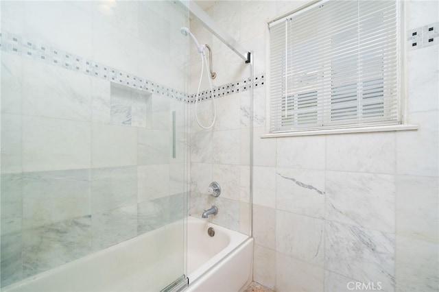 bathroom featuring combined bath / shower with glass door