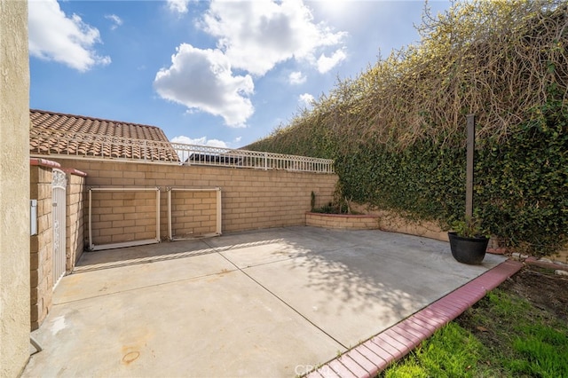 view of patio featuring fence