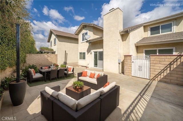 view of patio with a gate, fence, and outdoor lounge area