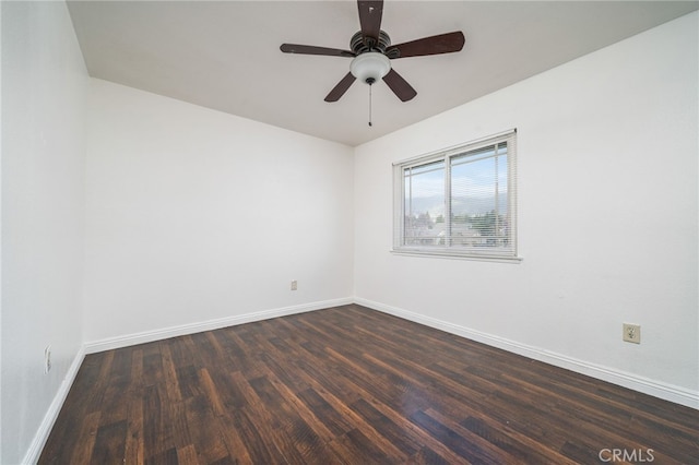 empty room with dark wood-style floors, ceiling fan, and baseboards