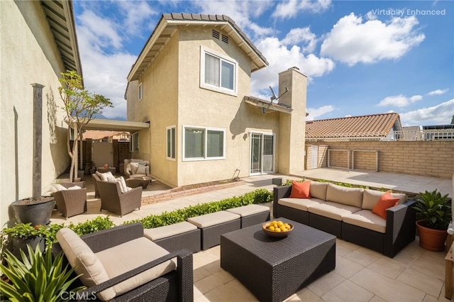 back of house with a patio, outdoor lounge area, fence, stucco siding, and a chimney