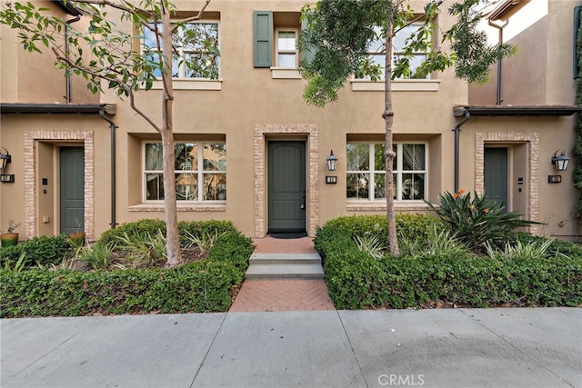 property entrance featuring stucco siding