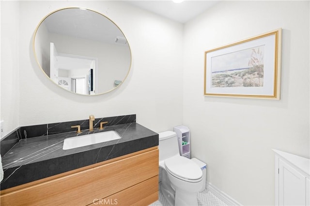 half bathroom with vanity and toilet