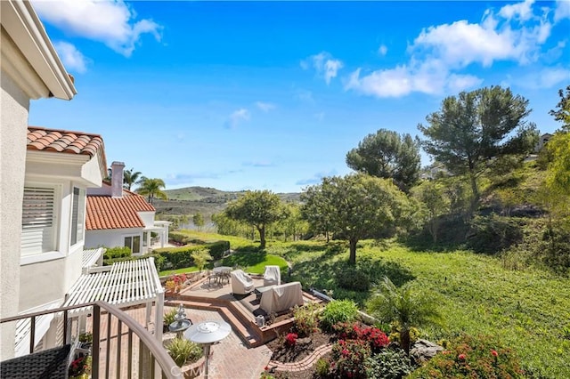 view of yard featuring a patio area and a mountain view