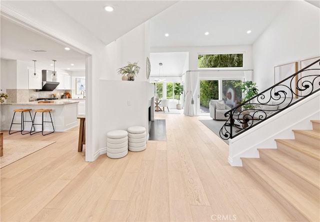 6 Baristo Unit 39, Irvine, CA 92612 - entrance foyer featuring light wood-type flooring, stairs, and recessed lighting