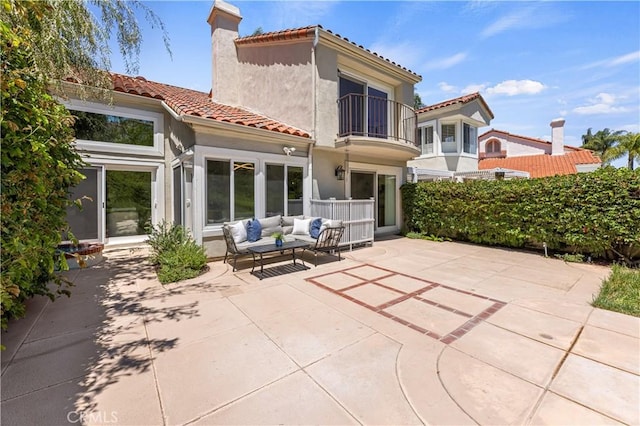 6 Baristo Unit 39, Irvine, CA 92612 - back of property featuring a patio, a balcony, an outdoor living space, a tile roof, and a chimney