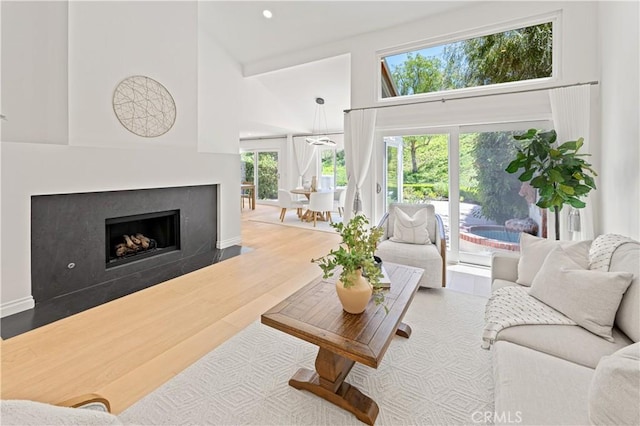 6 Baristo Unit 39, Irvine, CA 92612 - living area with a towering ceiling, a fireplace, and wood finished floors