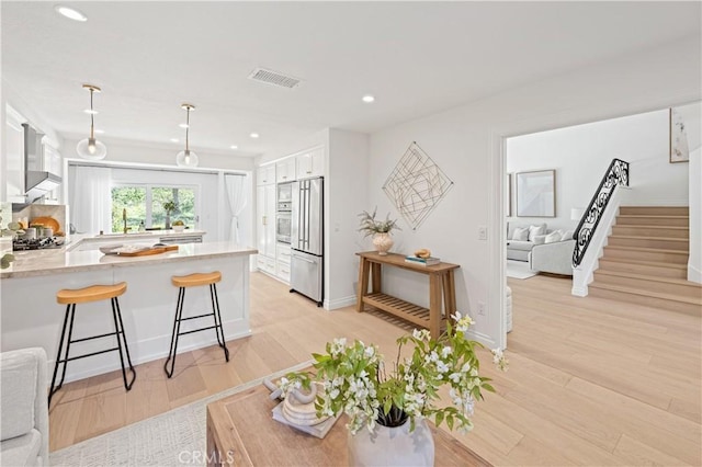 6 Baristo Unit 39, Irvine, CA 92612 - living room featuring recessed lighting, light wood-type flooring, stairway, and baseboards