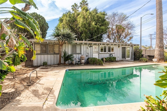 view of pool with a fenced in pool, a patio, and fence