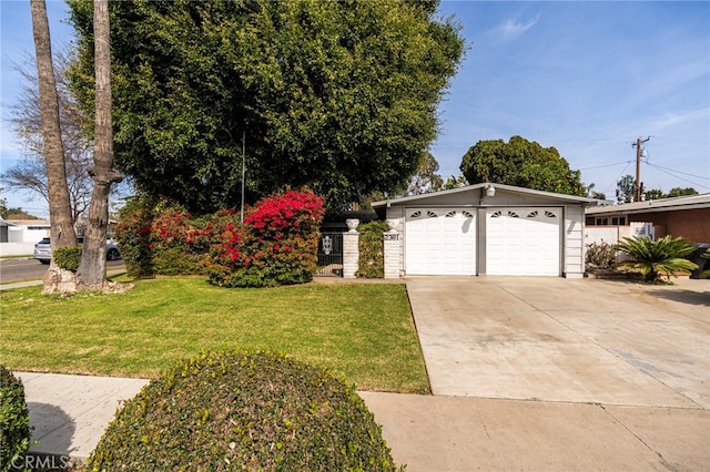 view of front of home with a garage, a front lawn, and concrete driveway