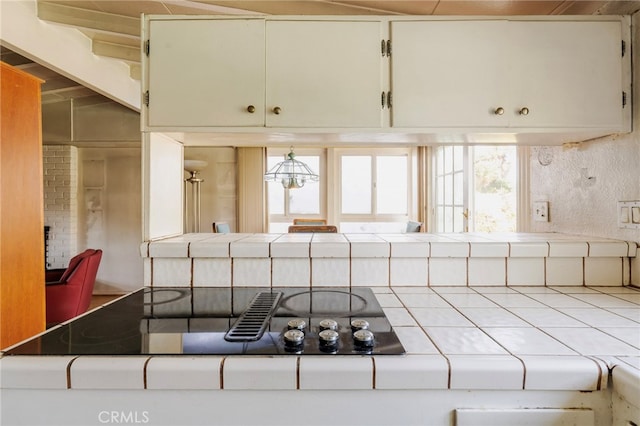 kitchen with tile countertops and black electric stovetop