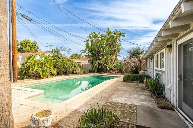 view of swimming pool featuring a fenced backyard, a fenced in pool, and a patio