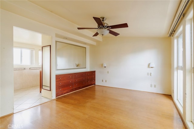 unfurnished room with a ceiling fan and light wood-style flooring