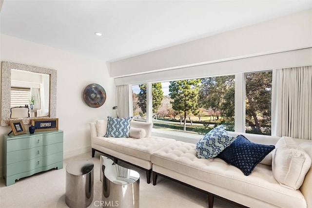 living area with recessed lighting, carpet, a healthy amount of sunlight, and baseboards