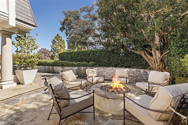 view of patio / terrace featuring an outdoor living space with a fire pit