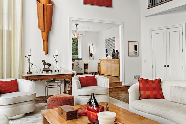 living room featuring visible vents, baseboards, and wood finished floors