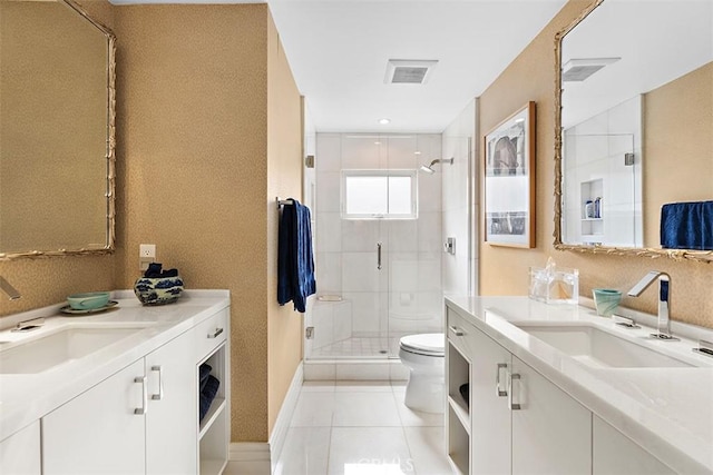bathroom featuring two vanities, a sink, toilet, and a shower stall