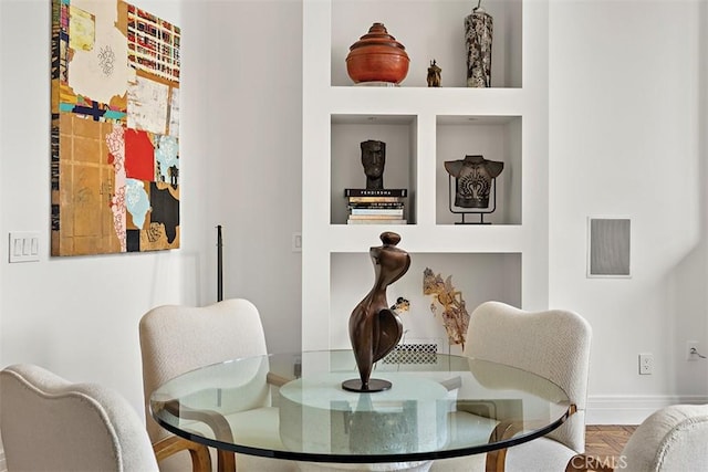 living area with visible vents and baseboards