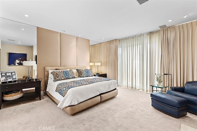 carpeted bedroom with visible vents and recessed lighting