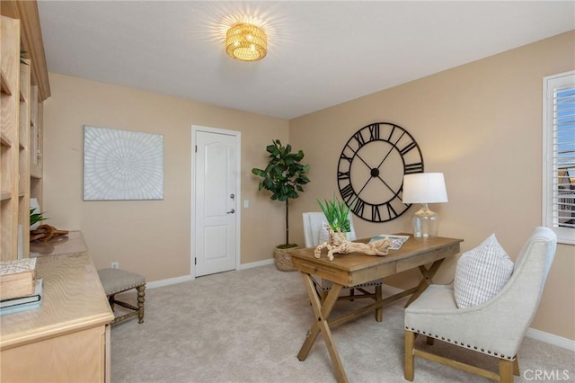 home office with baseboards and light colored carpet