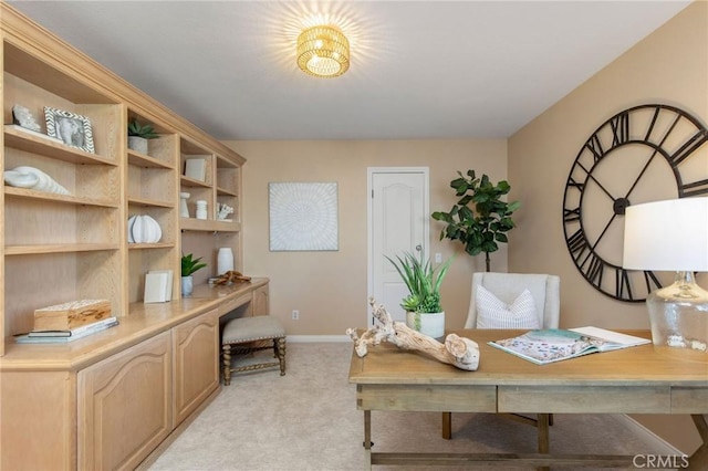 office with baseboards and light colored carpet