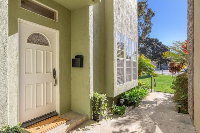 view of exterior entry with stucco siding