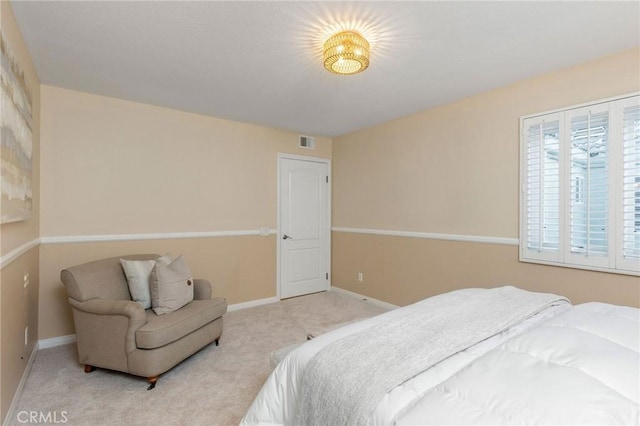 bedroom with carpet floors, visible vents, and baseboards